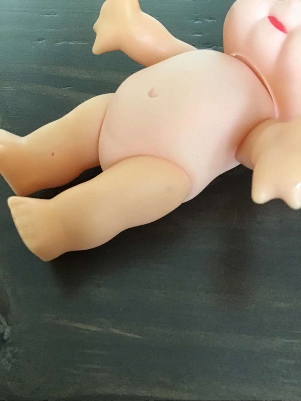 Vintage unmarked 6-inch hard plastic Kewpie doll from the mid-century era